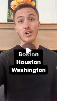 a man holding a microphone in front of his face with the words boston, washington on it