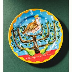 a plate with a bird painted on it and the words, a family is a four tree