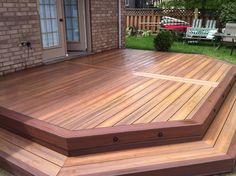 a large wooden deck in front of a house