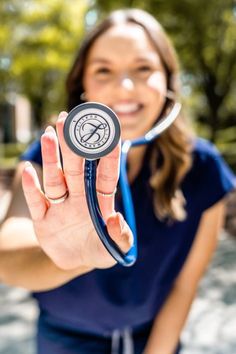 a woman holding a stethoscope in her hand