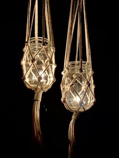 two hanging glass jars with rope and lights