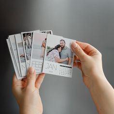 a person holding up four photos with the same photo on them in front of a gray background