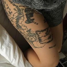 a woman's leg with tattoos on it