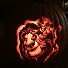 a carved pumpkin with an image of a lion on it's face in the dark