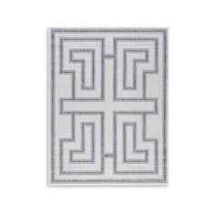 a white and blue rug with an interlocked design on the front, in grey