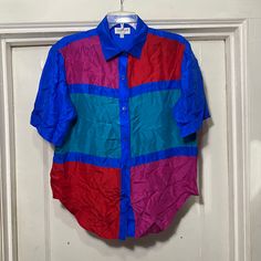 Vintage 100% silk Colorblock Button Down Shirt by Elizabeth Terrell Made in China.  Tag says size medium.  100% silk.  Bust measures 21'' flat across armpit to armpit and the length from shoulder seam to bottom along the side is 20''.  In great shape no rips or stains that I can find. Silk Shirt With Button Closure For Summer, Silk Summer Shirt With Button Closure, Summer Silk Shirt With Button Closure, Multicolor Silk Collared Blouse, Blue Silk Summer Shirt, Fitted Multicolor Silk Shirt, Multicolor Silk Short Sleeve Top, Retro Multicolor Silk Tops, Multicolor Silk Collared Shirt