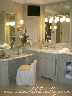 a large bathroom with two sinks and mirrors