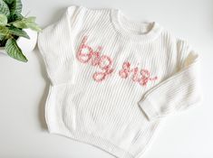 The perfect big sister gift! Sample shown is a sweater in cream with pink rose embroidery.  Big brother sweater here: https://www.etsy.com/listing/1710502447/big-brother-sweater-big-bro-sweater-baby?click_key=fcae6f62a8745508a07fa3f7205b9510004938d5%3A1710502447&click_sum=49b64b76&ref=shop_home_active_10&pro=1&frs=1 *If you're looking for a specific sweater or yarn color, please send me a message and I can source it for you. TO ORDER -Select size and sweater color via the drop down menus -In the personalization box, leave embroidery color SIZING AND FIT -All sweaters are an OVERSIZED fit, perfect for watching baby grow throughout their first year, layering, or having a long lasting, heirloom piece. If you'd like a more snug fit, order a size down. WASHING INSTRUCTIONS: Turn sweaters inside Big Sis Valentines Announcement, Big Sis Sweater, Leave Embroidery, Baby Announcement Big Sister, Baby Jumpers, Sister Announcement, Big Sister Announcement, Big Sister Gifts, Sister Shirt