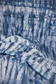 a blue and white tie dyed bed spread