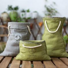 three bags sitting on top of a wooden table