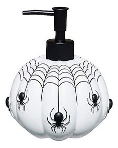 a soap dispenser with spider webs on it