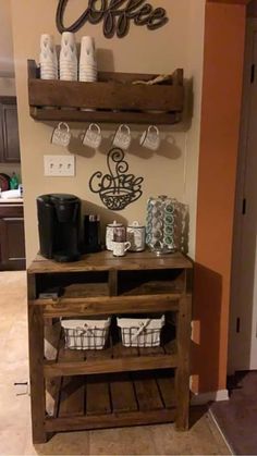 the coffee bar is made out of wood and has two baskets on it, along with some cups