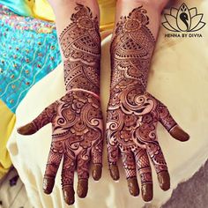 two hands with henna designs on them