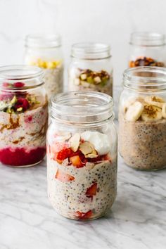 four mason jars filled with different types of food