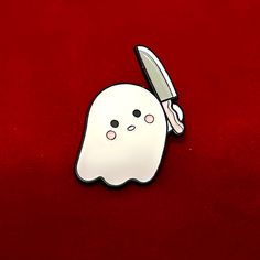 a white ghost with a knife sticking out of it's mouth on a red surface