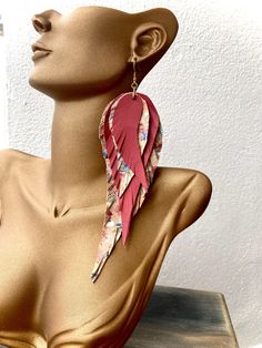 Dive into the epitome of bohemian elegance with our Pink and Ruby Red Leather  Feathered Statement Earrings. Each earring is meticulously handcrafted to perfection, ensuring a one-of-a-kind piece that exudes individuality. The long and lightweight design offers comfort without compromising on style, allowing you to adorn yourself with grace and ease. They are  the perfect accessory for any occasion, whether it's a casual day out or a special evening affair. Let them sway gently with your every m Adjustable Bohemian Wrap Earrings For Party, Adjustable Single Wrap Bohemian Earrings, Bohemian Adjustable Single Wrap Earring, Adjustable Bohemian Single Wrap Earring, Adjustable Single Bohemian Wrap Earring, Elegant Wrap Earrings For Festivals, Leather Feather Earrings, Extra Long Earrings, Cork Earrings