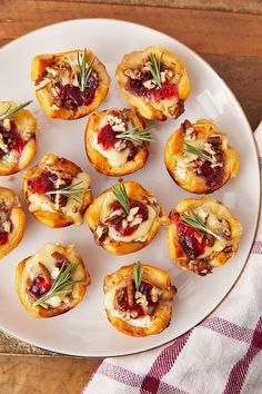 small appetizers with cranberry sauce and nuts on a white plate