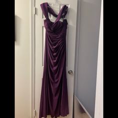 a purple dress hanging on a door