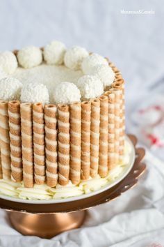 a cake with white frosting is on a plate