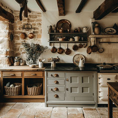 an old fashioned kitchen with pots and pans on the wall