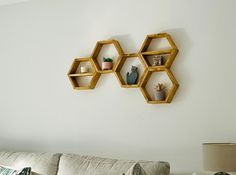 three hexagonal shelves on the wall above a couch