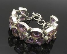 925 Sterling Silver - Faceted Multi-Shape Amethyst Shiny Chain Bracelet - BT7486  925 Sterling Silver - Faceted Multi-Shape Amethyst Shiny Chain Bracelet - BT7486  Jewelry Type:         Bracelet   Metal Type:            925 Silver  Metal Size:             7.75" Length  1" Height   Stone Type:            Amethyst  Condition:              N/A  Jewelry Weight:     63 Grams  PLEASE NOTE: THIS ITEM IS PRE-OWNED. ALTHOUGH MOST ITEMS ARE IN VERY GOOD CONDITION, SOME MAY NEED CLEANING AND/OR MINOR REPAI Modern Purple Bracelet Jewelry, Clear Pictures, Bracelet Metal, Metal Bracelets, Chain Bracelet, Locket, Types Of Metal, Metallic Silver, 925 Silver