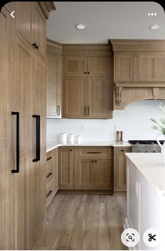 a kitchen with wooden cabinets and white counter tops