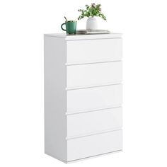 a white chest of drawers with a plant on top and a cup sitting on top