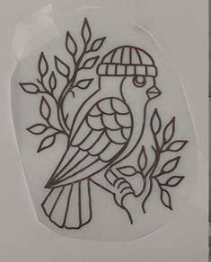 a stencil depicting a bird on a tree branch with leaves and a cage in the background