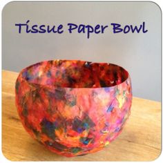 tissue paper bowl sitting on top of a wooden table with the words tissue paper bowl above it