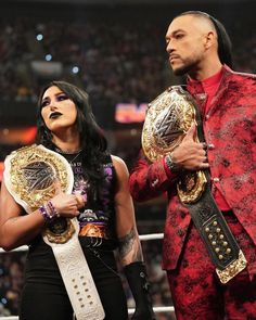 the rock and his wife are holding their wwe championship belts