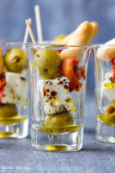 olives and feta shooters in small glasses with toothpicks