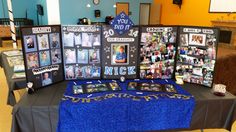 a table topped with pictures and chains on top of a blue cloth covered tablecloth