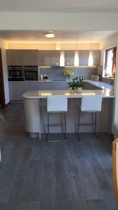 a kitchen with an island and two stools