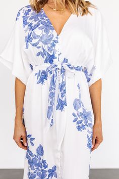 Delicate blue flowers on white background Textured Polyester with no stretch The kimono fit runs large and we recommend sizing down for a more fitted look V neckline Short kimono style flutter sleeves Functioning buttons down front Elastic waist with detachable waist tie Fully attached lining Dress may appear slightly sheer in different lightings, we recommend wearing a slip underneath Self: 100% Polyester Lining: 97% Polyester and 3% Spandex Trina is 5'6, cup size 32D, size 2 and is wearing size XS Kimono Maxi Dress, Maxi Dress White, Floral Print Kimono, Baltic Born, Short Kimono, Print Kimonos, Kimono Style, Blue Floral Print, White Maxi Dresses