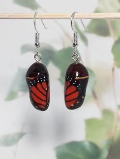 MONARCH CHRYSALIS EARRINGS - beautiful hand sculpted monarch butterfly chrysalis earrings, a great gift idea! by LadyDivergent on Etsy https://www.etsy.com/listing/691812474/monarch-chrysalis-earrings-beautiful Hand Painted Butterfly Jewelry Gift, Unique Hand Painted Butterfly Jewelry, Hand Painted Butterfly Jewelry For Gift, Unique Nickel-free Butterfly Earrings, Unique Butterfly Earrings For Jewelry Making, Nature-inspired Butterfly Earrings For Gift, Unique Butterfly-shaped Jewelry With Matching Earrings, Unique Handmade Butterfly Earrings, Monarch Chrysalis