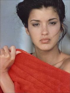 a young woman is wrapped in a red towel