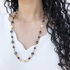 This beautiful necklace is perfect for those looking for an elegant and refined jewel. Handcrafted from high-quality gold-filled steel, it features an array of luminous and lustrous black Bohemian crystals, which catch the light enchantingly. The freshwater pearls, round and smooth, alternate with crystals, giving the necklace an even more precious and sophisticated appearance. The choice of purple semiprecious stones gives a touch of color to the necklace, creating a beautiful chromatic effect. The necklace is a perfect length for everyday wear or for a special occasion, and is lightweight and comfortable to wear. The elegant and luxurious design pairs perfectly with any type of clothing, from a simple t-shirt to the most elegant evening dress. This necklace with Bohemian crystals, freshw Elegant Long Pearl Necklace With Natural Stones, Elegant Long Necklace With Round Natural Stones, Elegant Long Necklace With Natural Stones For Gift, Elegant Black Long Necklace For Gift, Elegant Long Necklace For Jewelry Making With Gemstone Beads, Elegant Long Necklace With Gemstone Beads For Jewelry Making, Elegant Long Gemstone Beads Necklace For Jewelry Making, Elegant Long Necklace With Natural Stones, Elegant Gold Long Necklace With Natural Stones