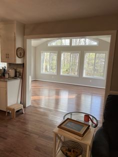 an empty living room with hard wood floors and lots of natural light in the windows