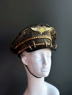 Our captain hat boasts an authentic steampunk aesthetic. Intricate gears, cogs, and spike elements adorn the hat, transporting you to an era of innovation and daring feats.


Age Group/Gender - Adult/Unisex

Size/Type - One size fits all adults

Mask Color - Gold Steampunk Top Hat With High Crown For Themed Events, Steampunk Hat For Themed Events, Steampunk High Crown Hat For Themed Events, Vintage High Crown Costume Hats For Themed Events, Steampunk Costume Accessories For Cosplay, Steampunk High Crown Costume Accessories For Festivals, Gold Steampunk Costume Accessories For Festival, Steampunk High Crown Costume Accessories For Cosplay, Vintage High Crown Costume Hats For Cosplay