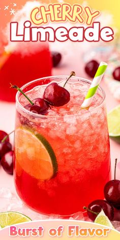 a red drink with cherries and lime on the rim