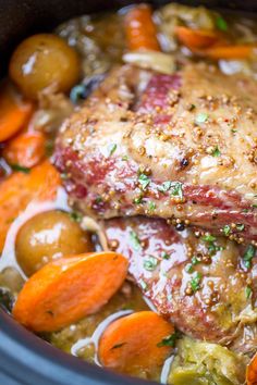 slow cooker corned beef dinner with carrots, potatoes and cabbage in a crock pot