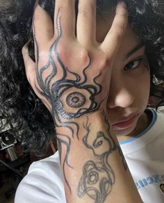 a woman with tattoos on her arm and hand