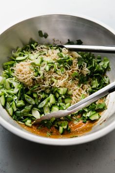 a white bowl filled with noodles and veggies