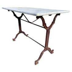 a marble top table with iron legs on an isolated white background for display or montage