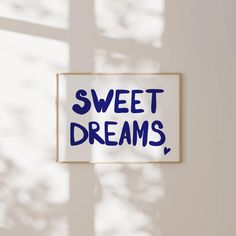 a sign that says sweet dreams hanging on the wall next to a window with sunlight streaming through it