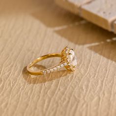 a diamond ring sitting on top of a piece of paper