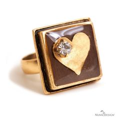 a close up of a ring with a heart on it