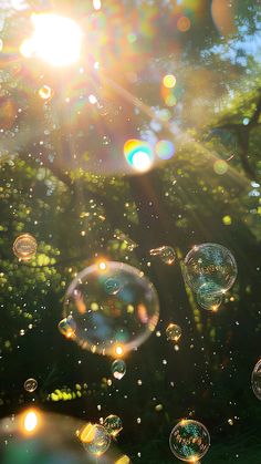 soap bubbles are floating in the air on a sunny day