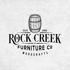 the logo for rock creek furniture co woodcrafts, with a barrel on top